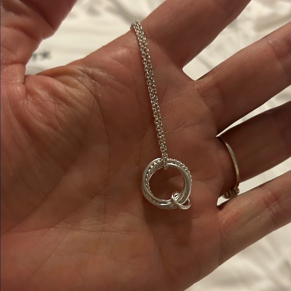 chain is a delicate silver necklace with a fine link chain.
Ns stamped on it
